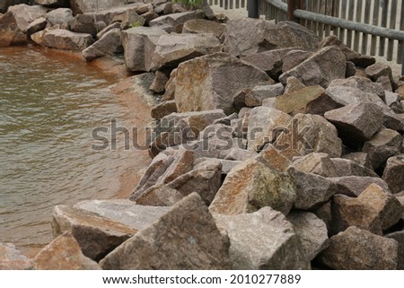 A piles of natural stones by the lake