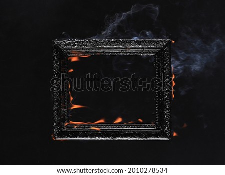 Victorian vintage frame on fire on black background