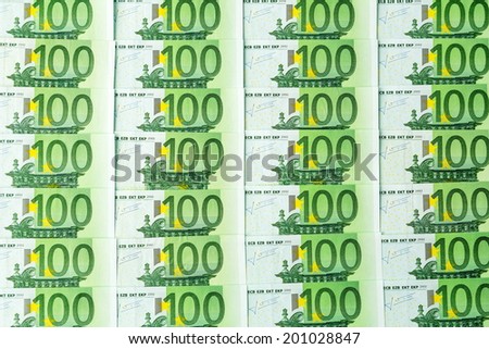 many einhhundert euro banknotes lie side by side. symbolic photo for wealth and investment