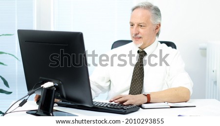 Senior businessman working on his computer