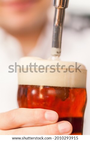 Detail of a bartender drawing a beer
