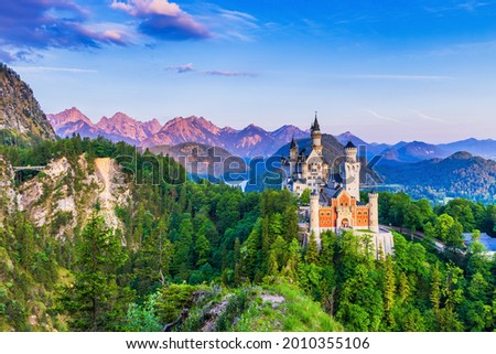Neuschwanstein Castle, Germany. Front view of the castle and Queen Mary's bridge. The Bavarian Alps in the background.