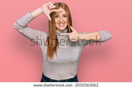 Young irish woman wearing casual clothes smiling making frame with hands and fingers with happy face. creativity and photography concept. 