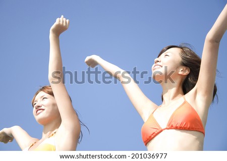 bikinied women who are stretching
