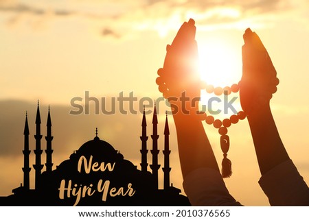 Hands of Muslim woman praying outdoors at sunset. Celebration of Islamic New Year Royalty-Free Stock Photo #2010376565