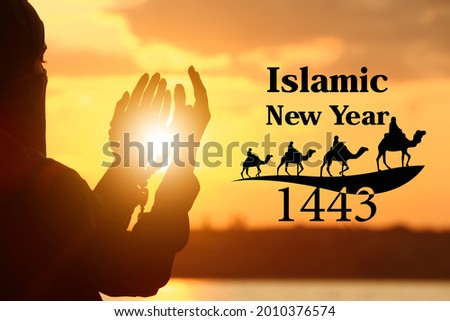 Muslim woman praying outdoors at sunset. Celebration of Islamic New Year Royalty-Free Stock Photo #2010376574