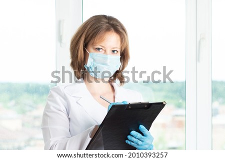 doctor receptionist,medical care,nurse stands at the window in clinic,smiling,health and medicine