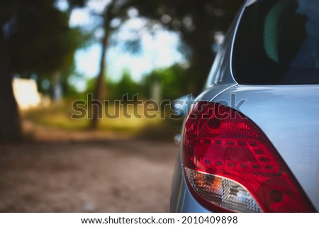 detail of a view of the tail lights of a car in the middle of the field