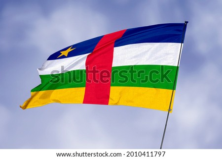Central African Republic flag isolated on sky background. National symbol of Central African Republic. Close up waving flag with clipping path.