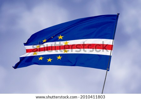 Cape Verde Islands flag isolated on sky background. National symbol of Cape Verde Islands. Close up waving flag with clipping path.
