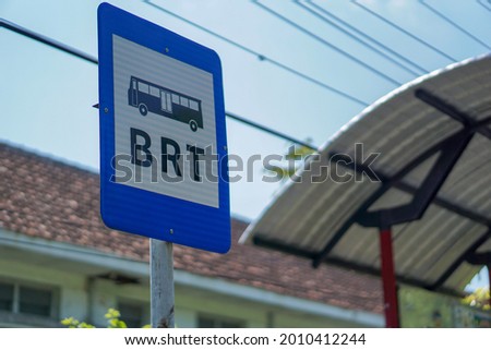 Bus Rapid Transit (BRT) signs in Indonesia, located at a bus stop, blue sign Royalty-Free Stock Photo #2010412244