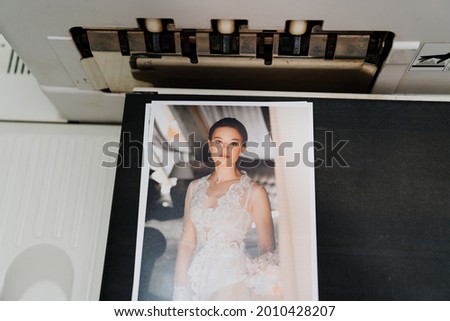 top view. printing of wedding photos in the photo laboratory. high-quality photo services for photographers and models. equipment for printing houses. saving memorable moments in photographs.
