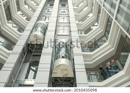 Image of high modern office building with elevators Royalty-Free Stock Photo #2010435098