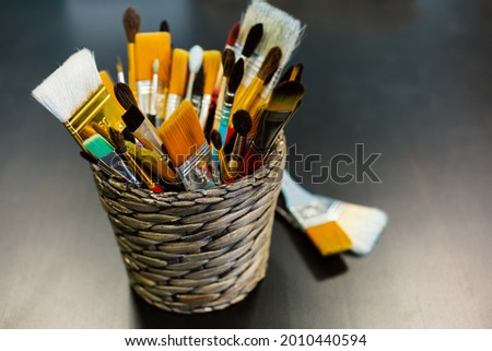 Artist brushes close-up on dark blurry background. Concept creativity, art, artschool. Selective focus. Copy space
