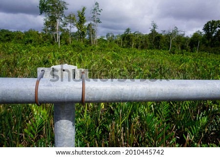 This photo shows a pipe clamp made of iron rods to hold the pipes together as a safety fence on the stage highway. This photo is an illustration of road construction etc.                            