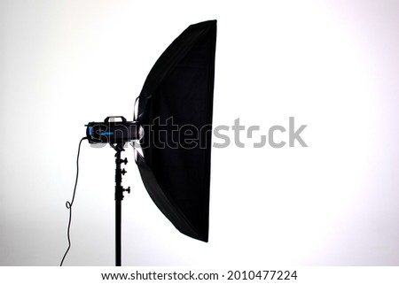 Professional photo studio strobe light with stripbox modifier isolated on white background Royalty-Free Stock Photo #2010477224