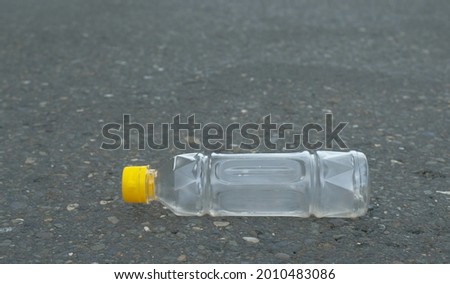 Plastic bottle waste - Plastic bottles on paved highway