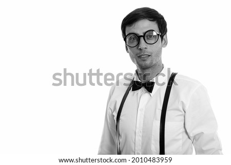Studio shot of young handsome businessman isolated against white background in black and white