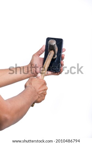 A man is breaking a smartphone with a big hammer