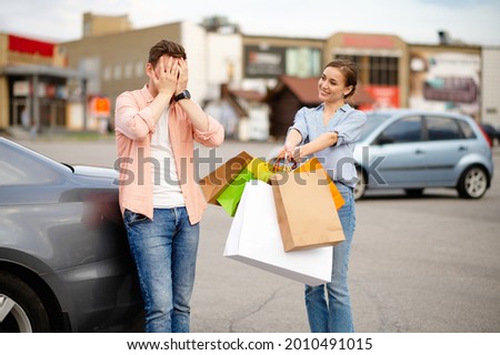 Angry husband does not want to carry bags, parking