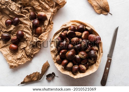 Top view of chestnuts on delicate background  Royalty-Free Stock Photo #2010521069