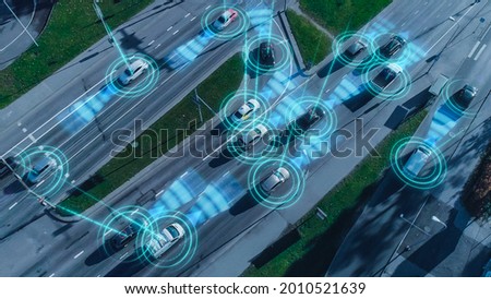 Top Down Aerial Drone: Autonomous Self Driving Cars Moving Through City. Concept: Artificial Intelligence Scans Surrounding Environment, Detecting Cars, Avoids Traffic Jams and Drives Safely. Royalty-Free Stock Photo #2010521639