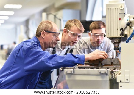 Group of young people in technical vocational training with teacher  Royalty-Free Stock Photo #2010529337