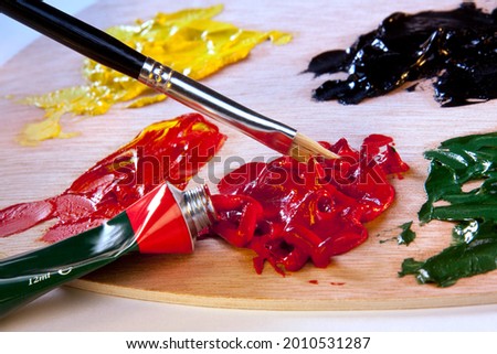 Arts and Crafts - Painting with oil paints, a type of slow-drying paint that consists of particles of pigment suspended in a drying oil, commonly linseed oil. Royalty-Free Stock Photo #2010531287