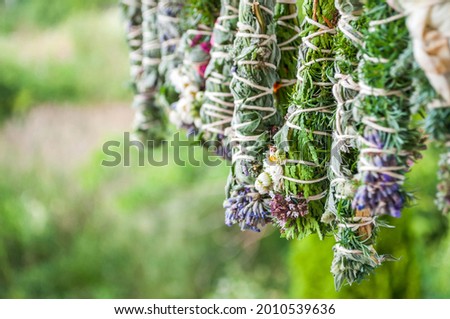 Smudge sticks on the rope. Dried herbs bound in bundles and hung on the rope. Royalty-Free Stock Photo #2010539636