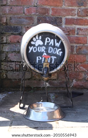 Sign for free dog water outside a pub. Paw your dog a pint.