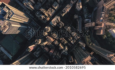 AERIAL. Top view of huge city with skyscrapers at the sunrise or sunset. Beautiful sunrise over the Victoria bay from the peak view point in Hong Kong, China Royalty-Free Stock Photo #2010582695