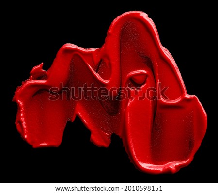Smudged red lipstick isolated on black background
