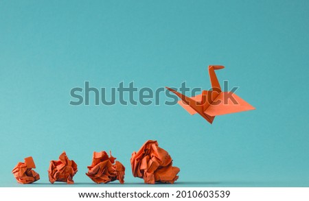 New ideas or transformation concept with crumpled paper balls and a crane, teamwork, creativity, business concept Royalty-Free Stock Photo #2010603539