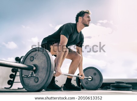 Gym fitness weightlifting deadlift man bodybuilding powerlifting at outdoor summer health club. Bodybuilder doing barbell weight lifting training workout with heavy bar. Royalty-Free Stock Photo #2010613352