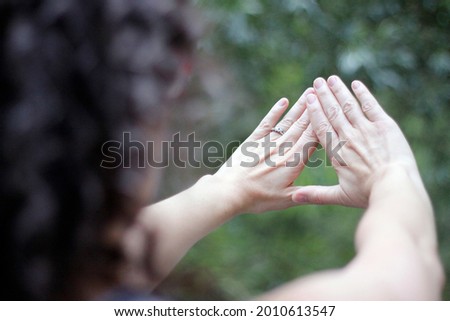  female forming a triangle with hands Royalty-Free Stock Photo #2010613547