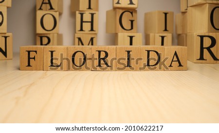 The word Florida was created from wooden letter cubes. Cities and words. close up.