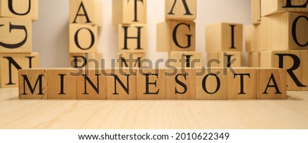 The word Minnesota was created from wooden letter cubes. Cities and words. close up.