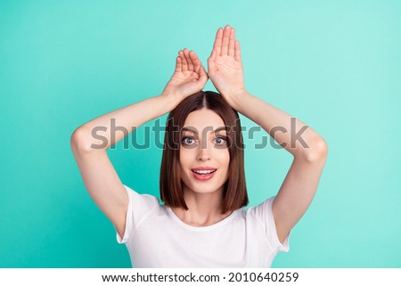 Photo of cute brunette hair funny lady hand up wear white t-shirt isolated on teal color background