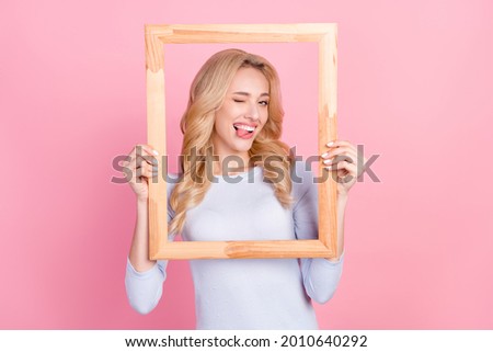 Photo of funky happy young nice woman hold wooden frame make picture isolated on pink color background