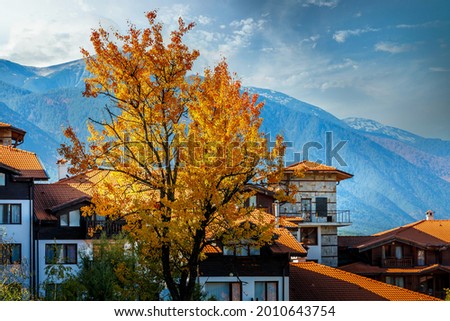 Bansko, Bulgaria, autumn trees and houses Royalty-Free Stock Photo #2010643754