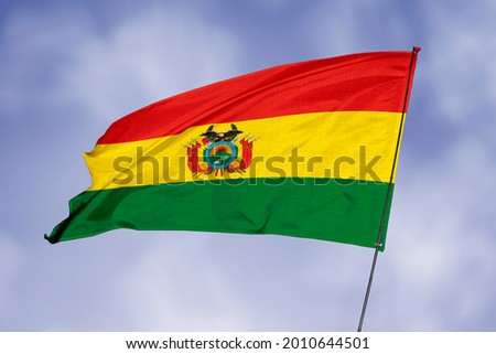 Bolivia flag isolated on sky background. National symbol of Bolivia. Close up waving flag with clipping path.