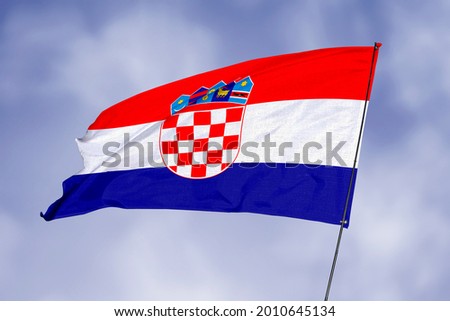 Croatia flag isolated on sky background. National symbol of Croatia. Close up waving flag with clipping path.