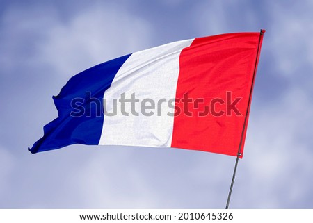 France flag isolated on sky background. National symbol of France. Close up waving flag with clipping path.