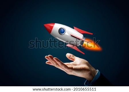 Rocket growth concept. Symbol of fast growth – hand with holding gesture and cartoon rocket flying above hand.