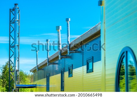 Industrial view of a modern dairy plant, industrial zone of the dairy industry against a blue sky background. A picture of environmentally friendly and safe dairy production. 