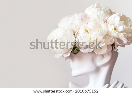 Fresh bunch of white peonies in vase in shape of womens face on light background. Trendy Ceramic Vase of human head, Handmade Modern Statue Art Flower Vase. Card Concept, copy space for text Royalty-Free Stock Photo #2010675152