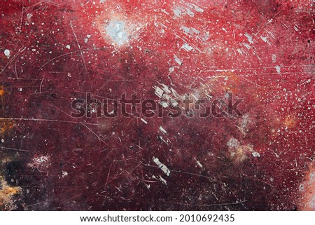 Aged rusty red weathered metal background with cracks, scratches and spots or grunge rough surface metal backdrop.