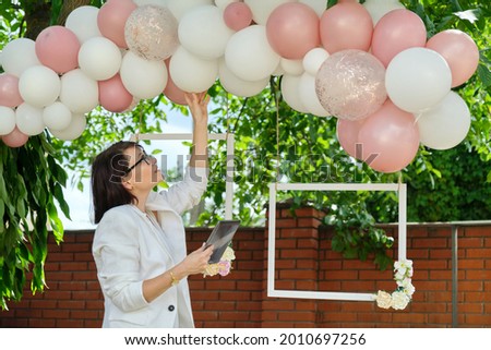 Decorating the garden with balloons for a party, ceremony Royalty-Free Stock Photo #2010697256