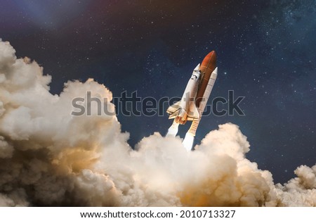 Space shuttle launch in the clouds to outer space. Dark space with stars on background. Sky and clouds. Spaceship flight. Elements of this image furnished by NASA