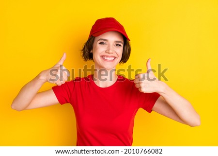 Photo of nice optimistic brown hair lady thumb up wear t-shirt cap isolated on yellow color background